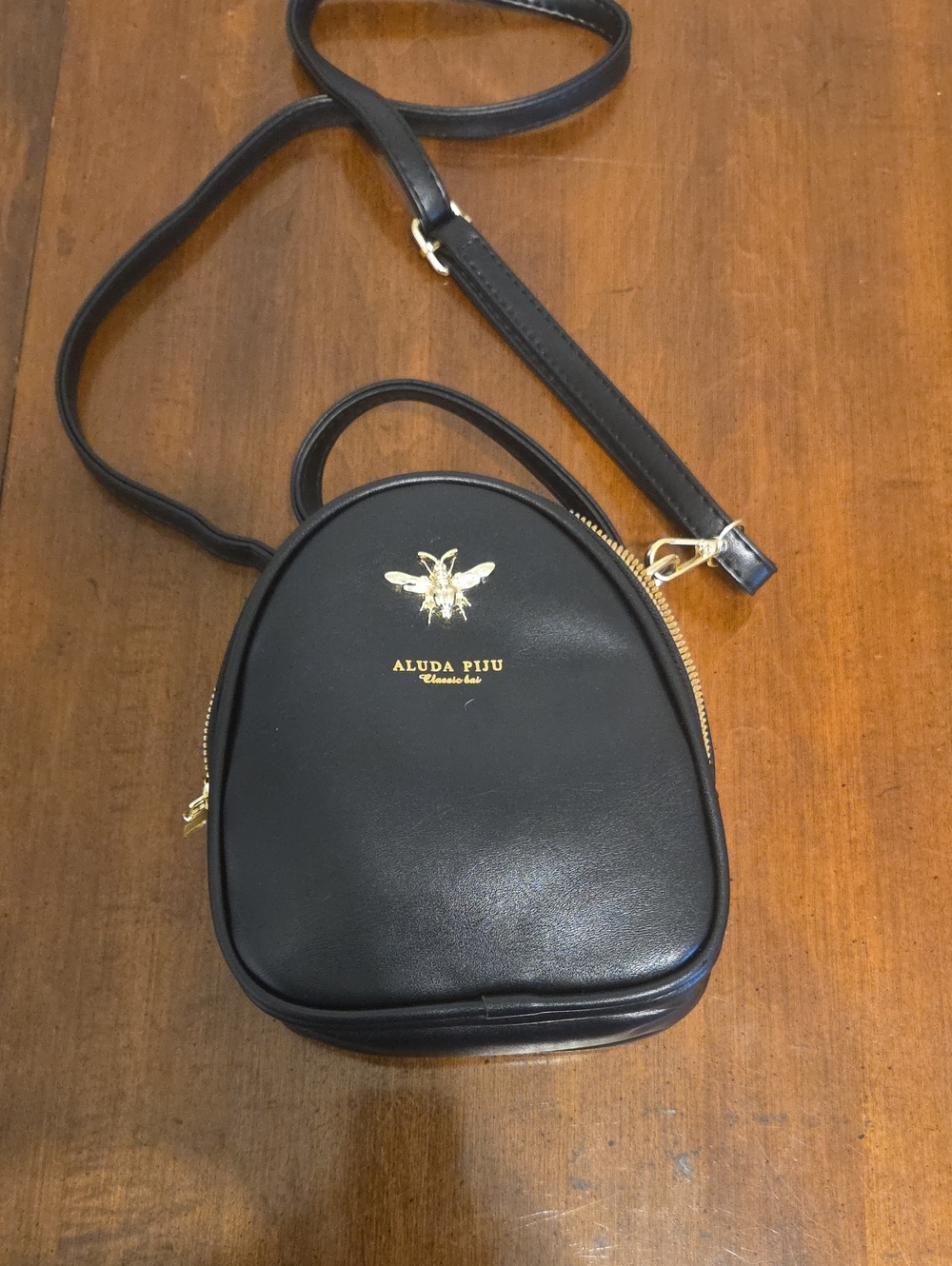 Black Crossbody Bag with Gold Bee Emblem